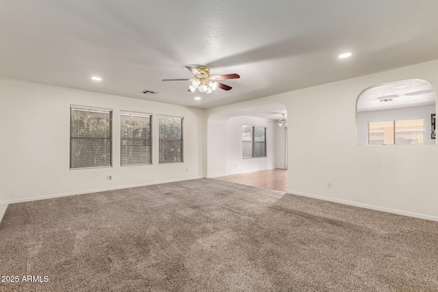 carpeted empty room with ceiling fan