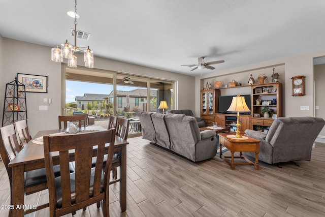 dining room with light hardwood / wood-style floors and ceiling fan