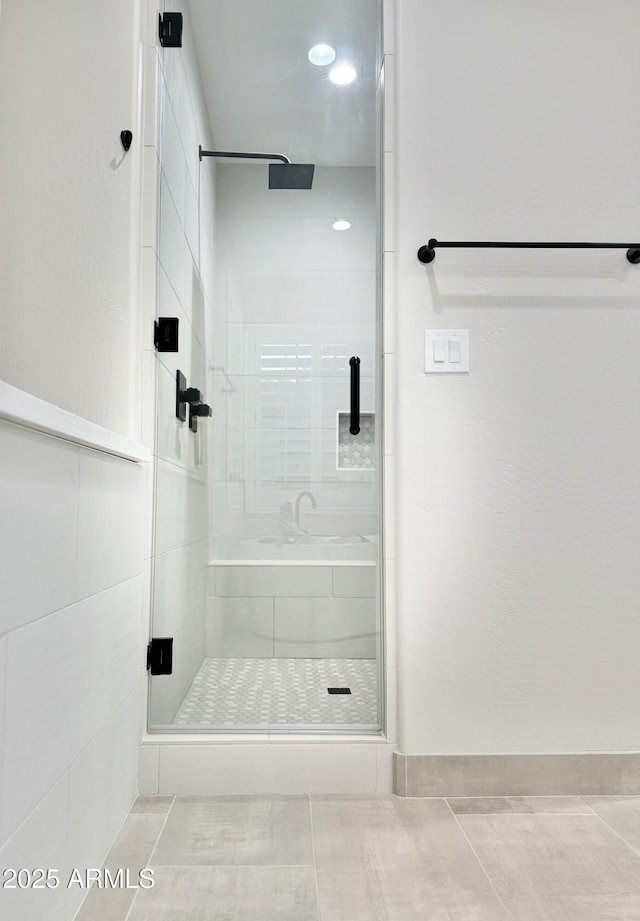 bathroom featuring a shower with door and tile patterned flooring