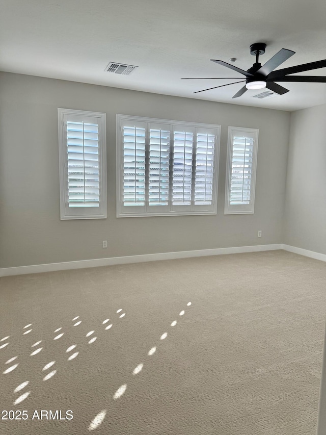 empty room with carpet flooring and ceiling fan