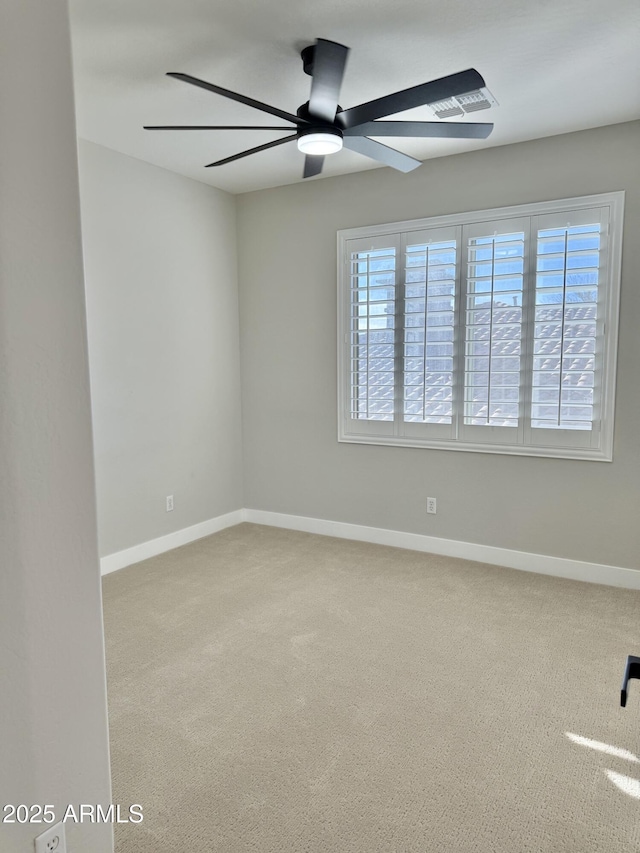 spare room featuring ceiling fan and carpet