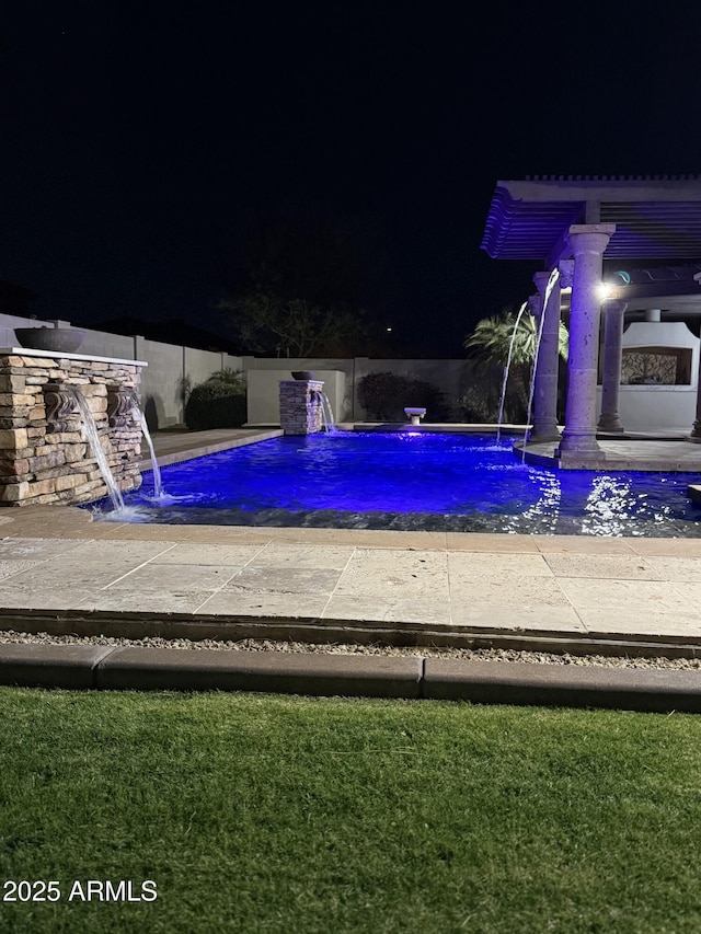 view of pool at night