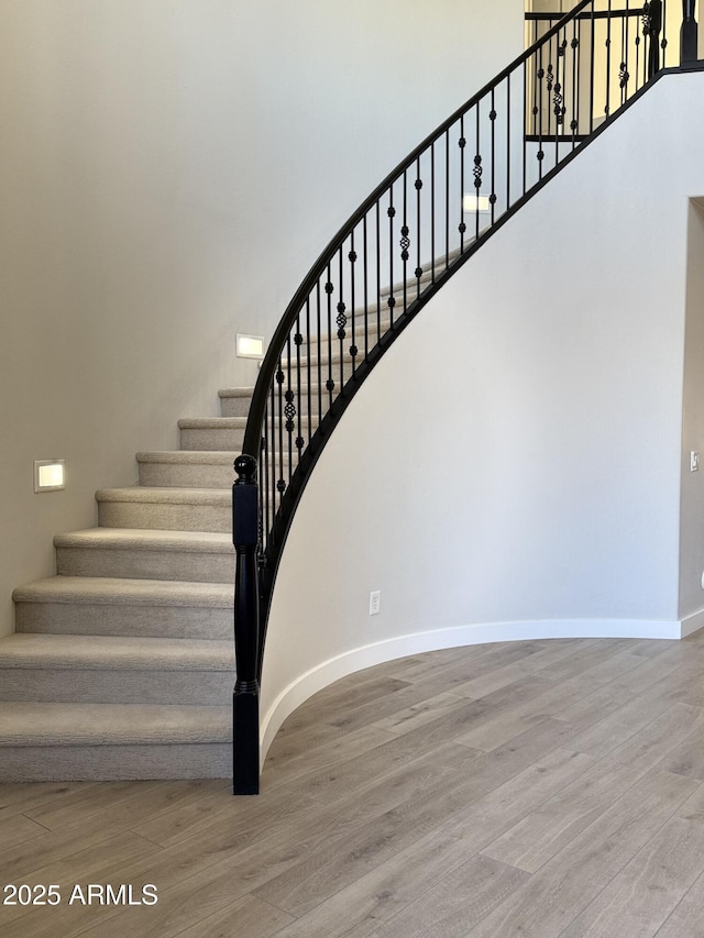 staircase with wood-type flooring