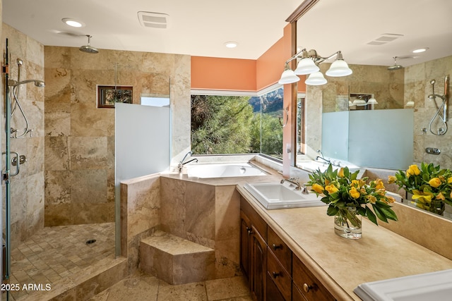 bathroom featuring vanity and independent shower and bath