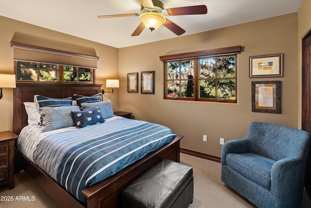 bedroom featuring light colored carpet and ceiling fan