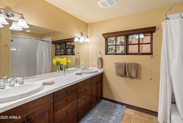 bathroom with tile patterned floors and vanity