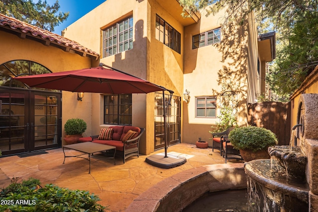 view of patio featuring an outdoor living space and french doors