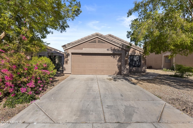 ranch-style home with an attached garage, concrete driveway, and stucco siding