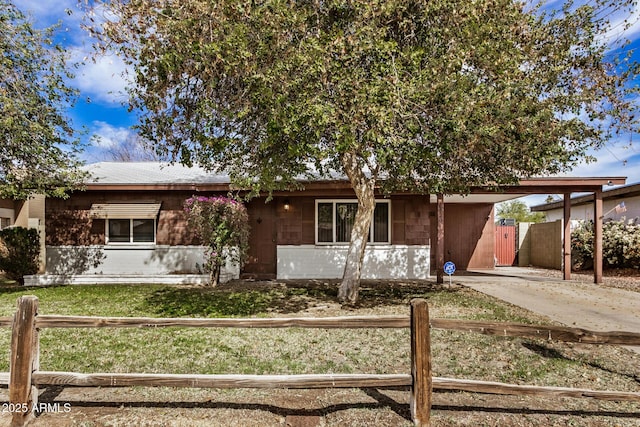 view of front of property featuring a carport and a front lawn