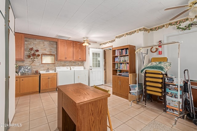 kitchen featuring backsplash, sink, washing machine and dryer, and light tile patterned floors