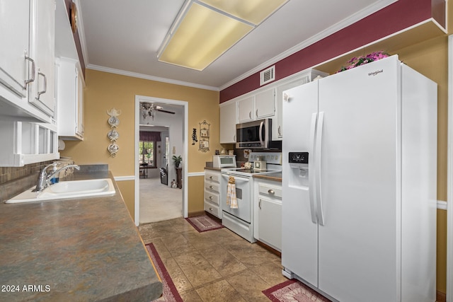 kitchen featuring white appliances, sink, ceiling fan, white cabinets, and crown molding