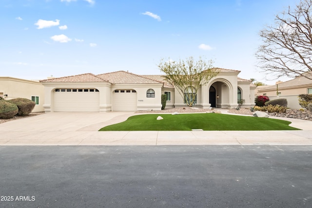 mediterranean / spanish home featuring a garage