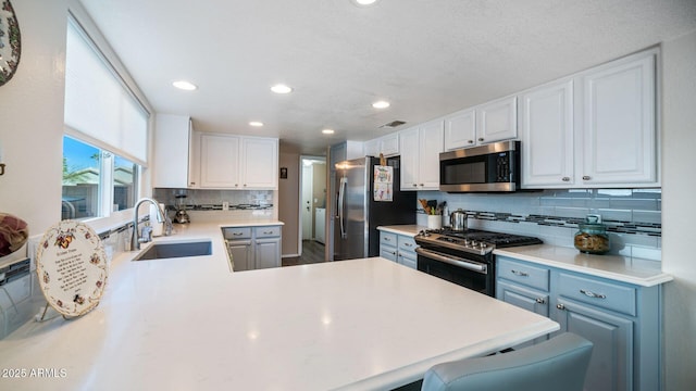 kitchen with white cabinetry, sink, and appliances with stainless steel finishes