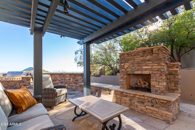 view of patio / terrace featuring a pergola, an outdoor living space with a fireplace, and an outdoor kitchen