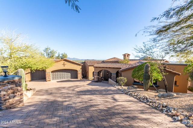 mediterranean / spanish-style home with a garage