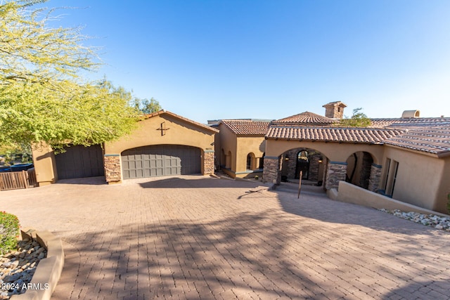 mediterranean / spanish-style home with a garage