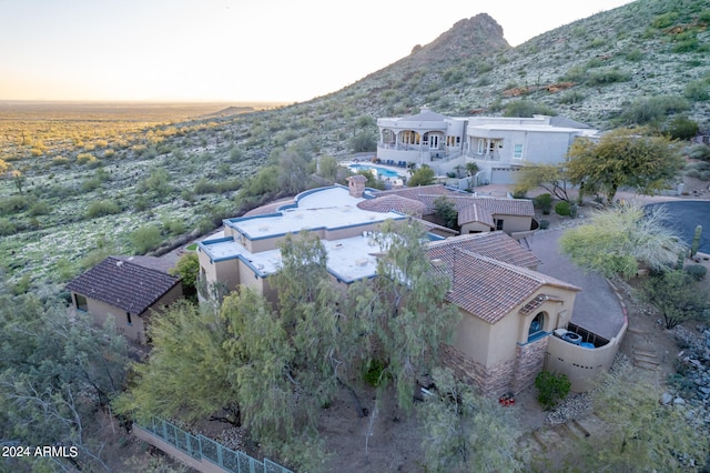 aerial view at dusk featuring a mountain view