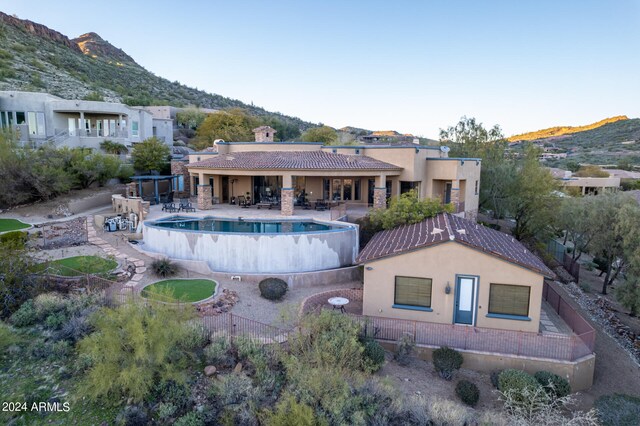 view of swimming pool featuring a mountain view and a patio area