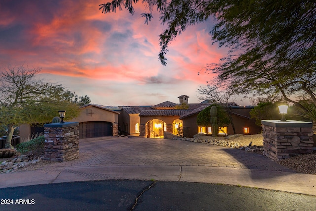 mediterranean / spanish-style home with a garage