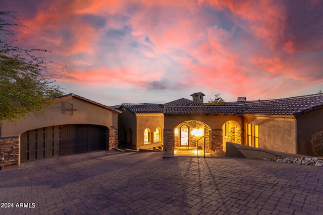 mediterranean / spanish-style home with a garage