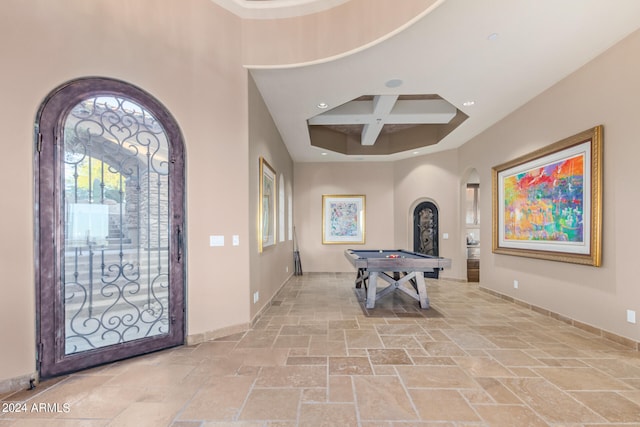 tiled entrance foyer with coffered ceiling, pool table, and beamed ceiling