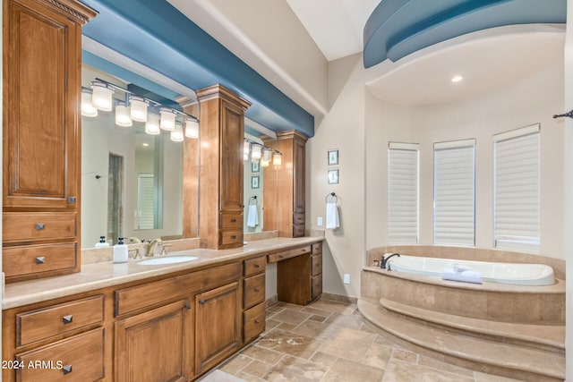 bathroom with a tub, tile floors, and oversized vanity