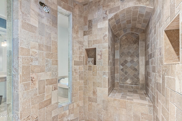 bathroom with tiled shower