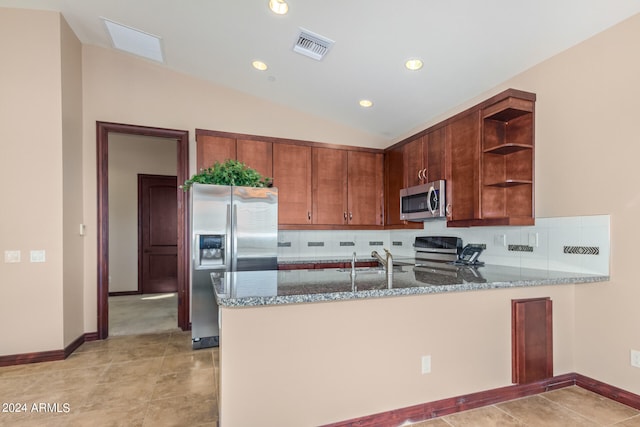 kitchen with light tile flooring, stone counters, tasteful backsplash, and appliances with stainless steel finishes