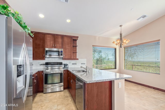 kitchen with a chandelier, stainless steel appliances, light tile flooring, kitchen peninsula, and backsplash