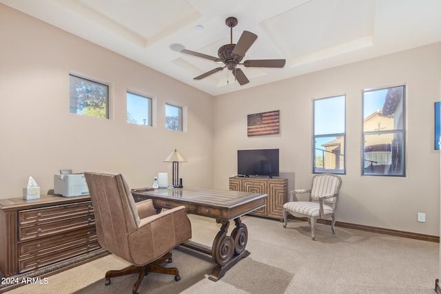 office space featuring ceiling fan, light colored carpet, and a raised ceiling