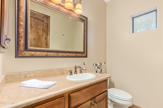 bathroom featuring toilet and large vanity