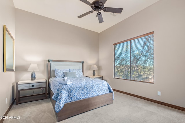 bedroom featuring light carpet, ceiling fan, and vaulted ceiling