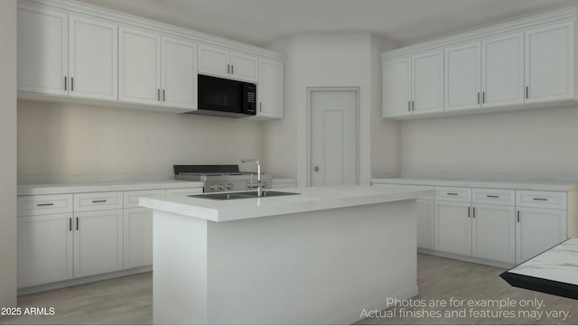 kitchen with white cabinetry, light hardwood / wood-style floors, sink, and a center island with sink