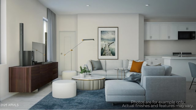 living room featuring sink, built in desk, and light hardwood / wood-style flooring