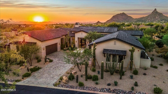 view of front of property featuring a garage and a mountain view