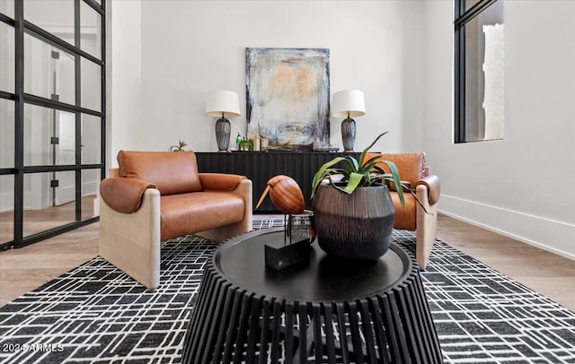 sitting room featuring hardwood / wood-style flooring and a healthy amount of sunlight