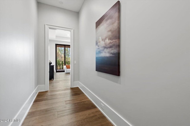 hall with wood-type flooring