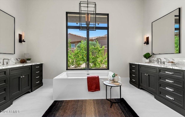 bathroom featuring vanity and a bath