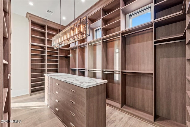 spacious closet featuring light wood-type flooring