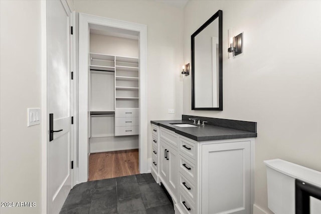 bathroom featuring hardwood / wood-style flooring, vanity, and toilet