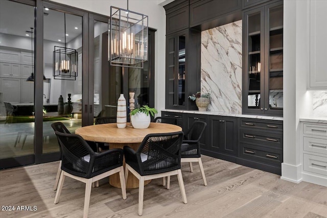 dining room with a chandelier and light wood-type flooring