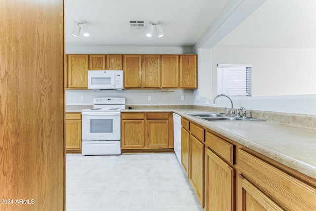 kitchen featuring white appliances and sink