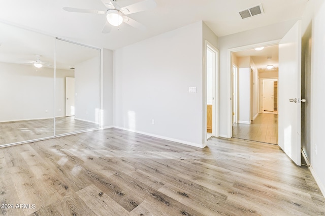 spare room with ceiling fan and light hardwood / wood-style flooring