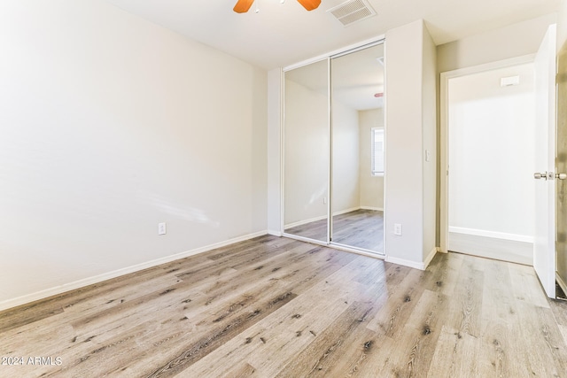 unfurnished bedroom featuring a closet, ceiling fan, and light hardwood / wood-style floors