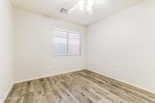 spare room featuring light wood-type flooring and ceiling fan