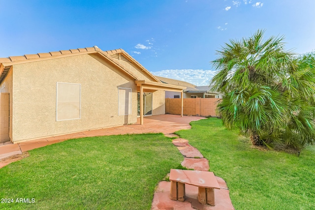 back of property with a patio area and a lawn