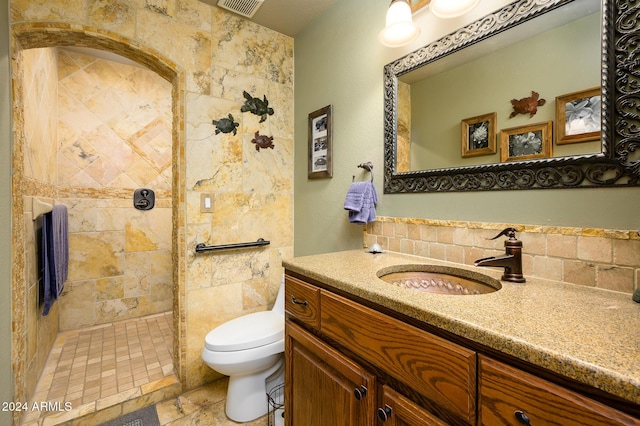 5701 N 105th Ln, Glendale, AZ 85307 - full bathroom featuring vanity, tasteful backsplash, toilet, and a tile shower