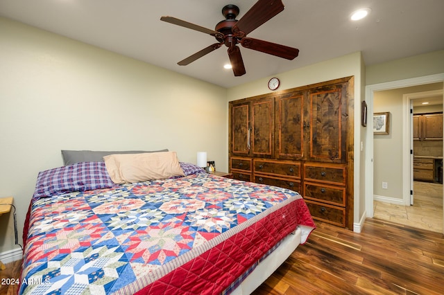 bedroom featuring ceiling fan and dark hardwood / wood-style flooring