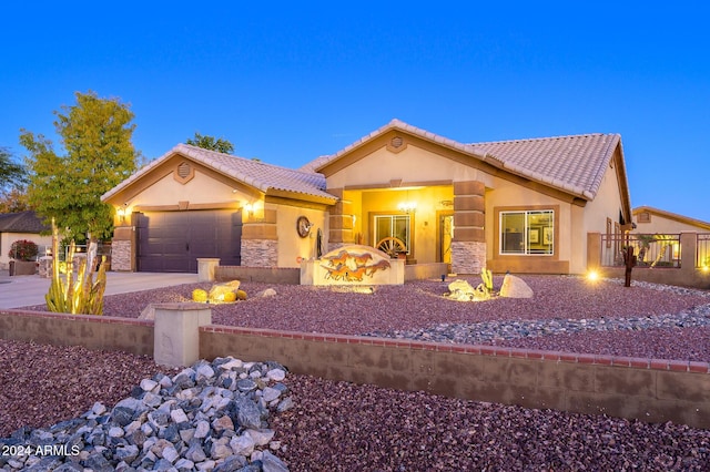 5701 N 105th Ln, Glendale, AZ 85307 - view of front facade with stucco siding, a tiled roof, a garage, concrete driveway, and stone siding
