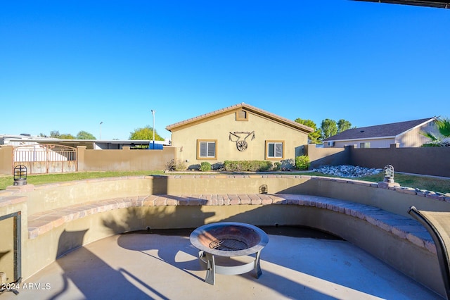 view of swimming pool with a patio and an outdoor fire pit